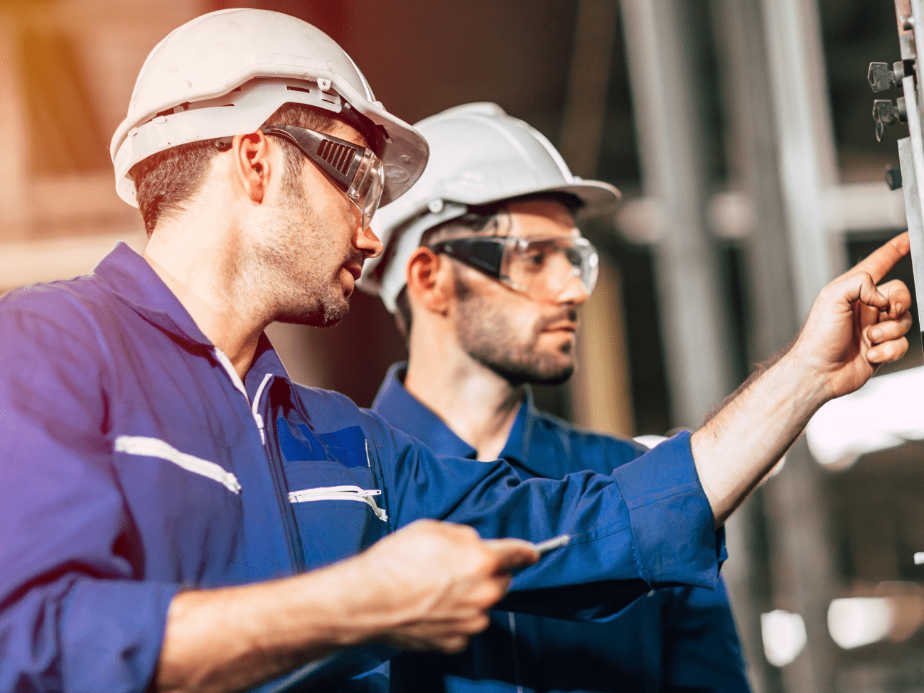 Training standards - Two Men In PPE Looking Inspecting Equipment
