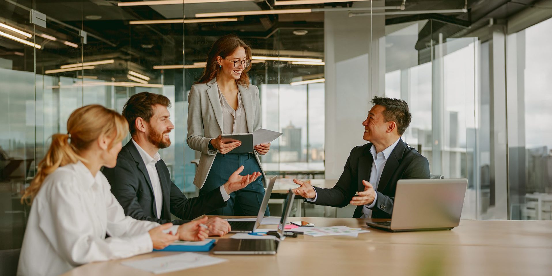 A Dynamic Business Meeting In A Modern Office Brings Together Diverse Professionals For Innovation