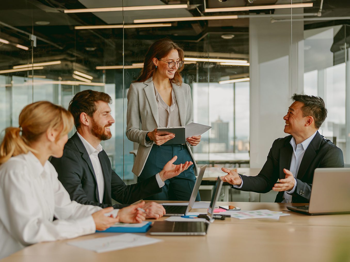 A Dynamic Business Meeting In A Modern Office Brings Together Diverse Professionals For Innovation