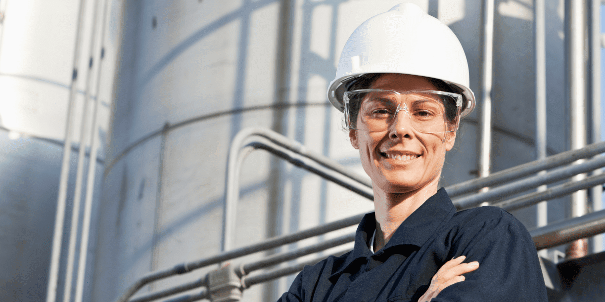 ECITB jobs enable you to help workers in industry like this woman in hard hat and safety glasses