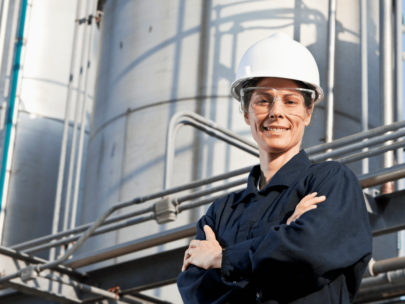 ECITB jobs enable you to help workers in industry like this woman in hard hat and safety glasses