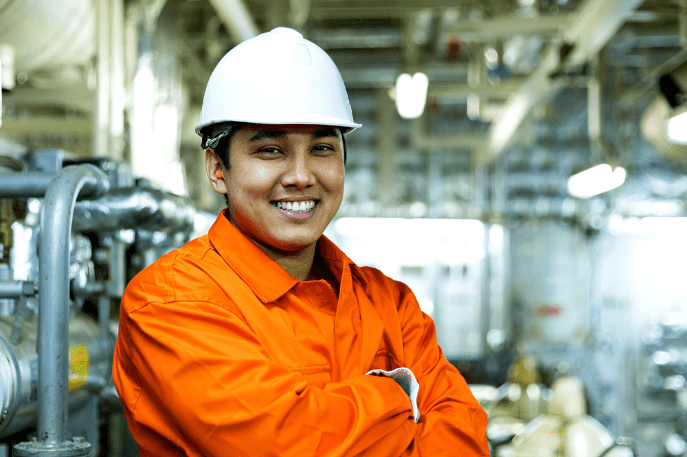 Man Wearing White Hard Had A Orange Overalls Smiling