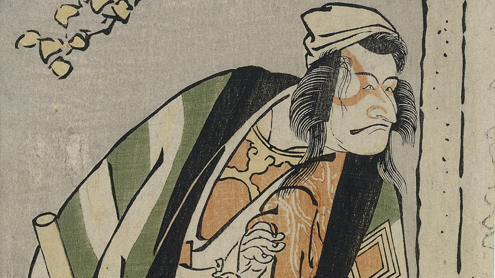 A male figure wearing a large coat and hat hold a stick looking towards his left.