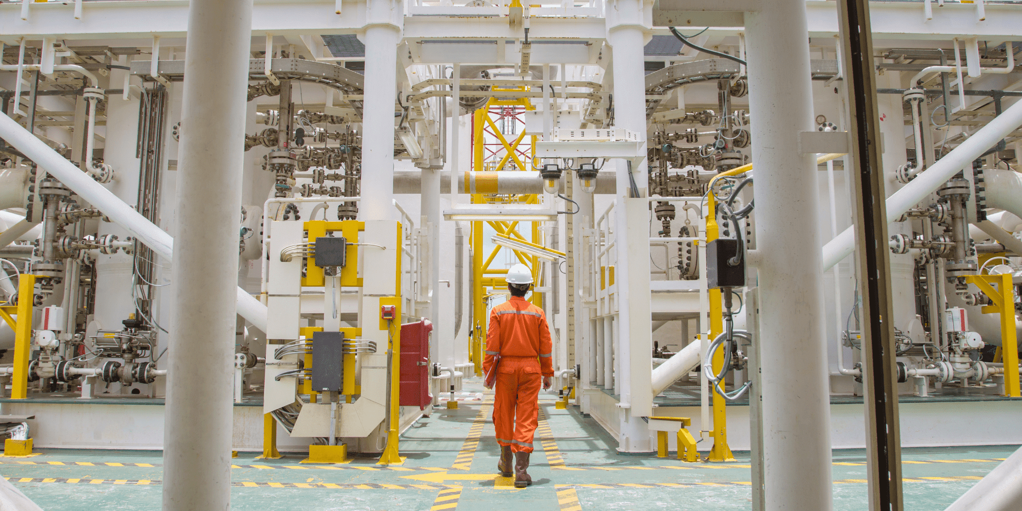 Site Operations Man Dressed In Orange Standing On Oil Rig