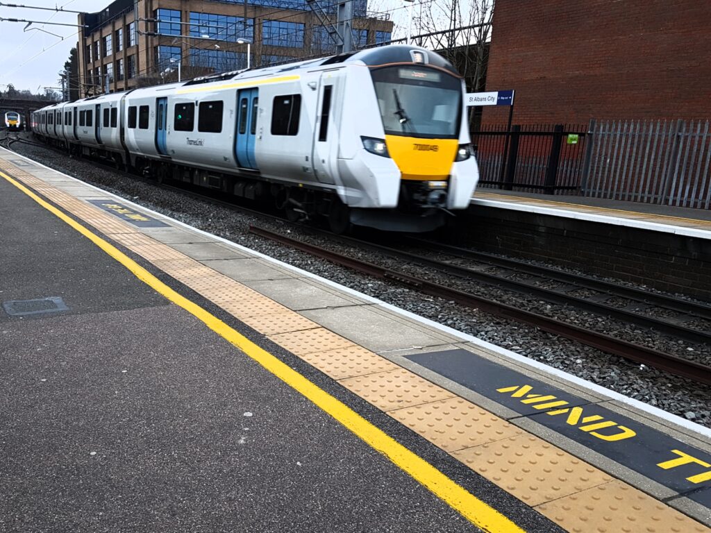 a Thameslink train arriving into a station