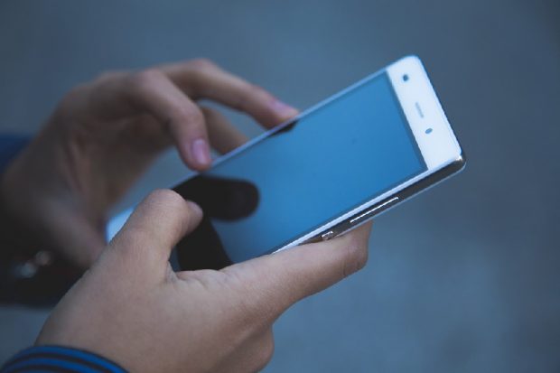 A person using their smart phone.