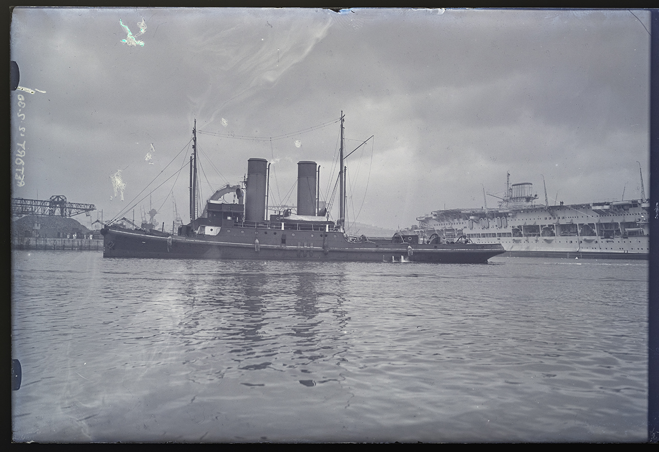 N4525; A starboard broadside view of the fleet minesweeper Rowena (1944) under way in Grand Harbour, Malta.  Her pendant number is M384.  In the background is the frigate Mermaid (1943).  A copy negative of a small photographic print.