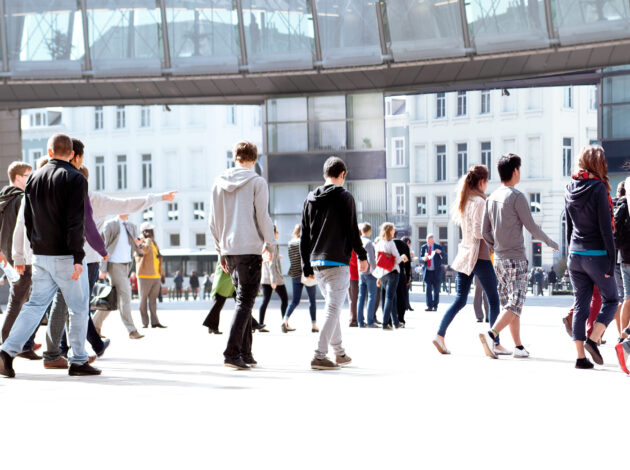 People walking around going about their day in an urban setting