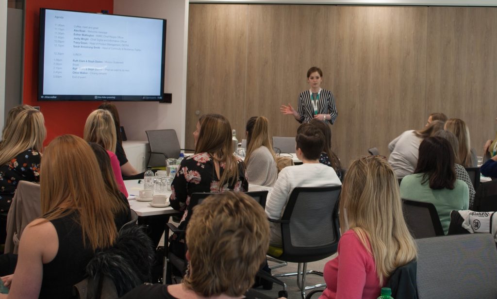 Chloe Walker presenting in front of an audience at Women in Digital