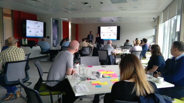Content designers watch a presentation on user research