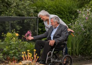 A male wheelchair user with his carer
