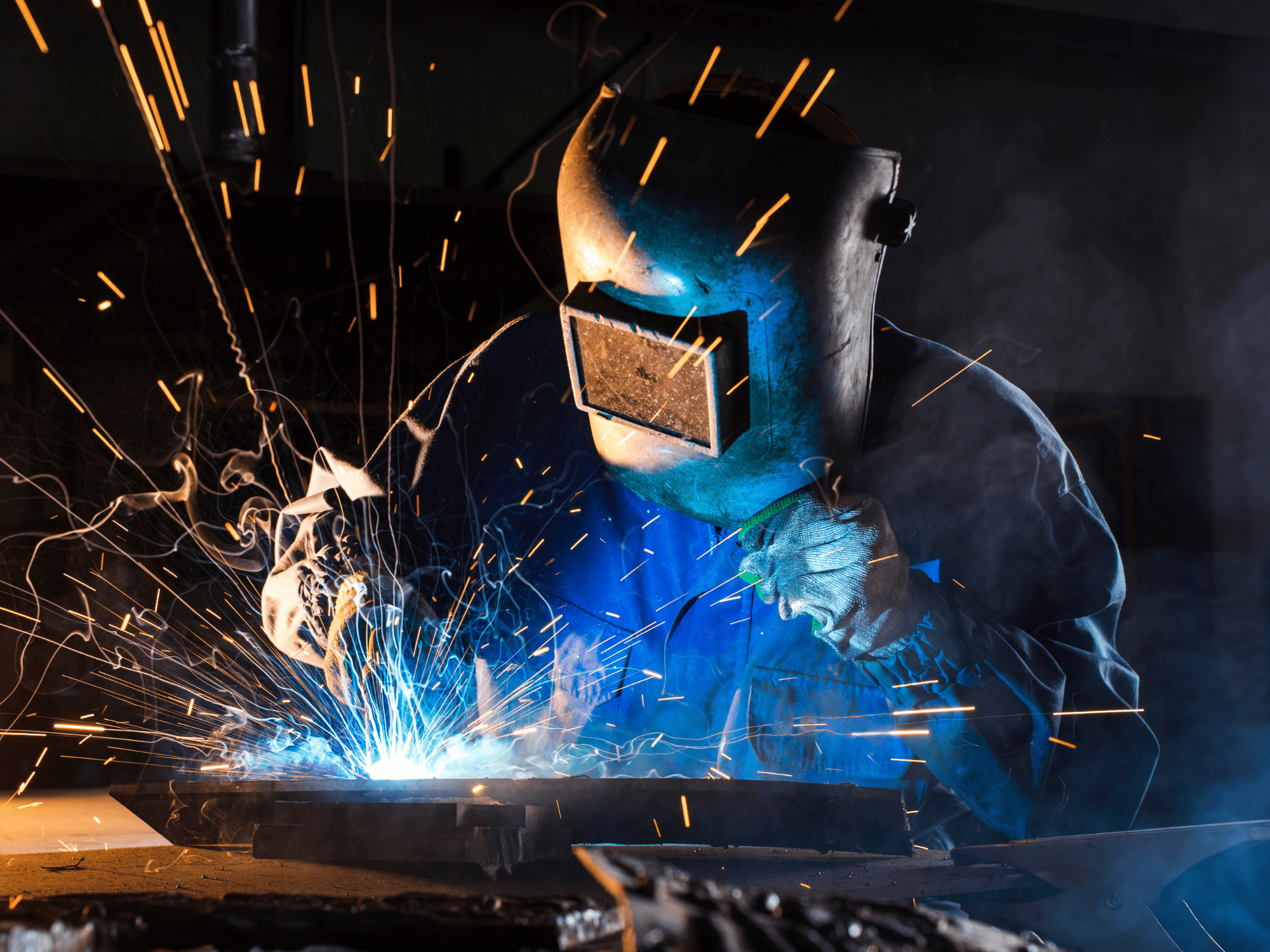 Welding training and welding qualifications can help people like this Person In PPE Welding In A Dark Room