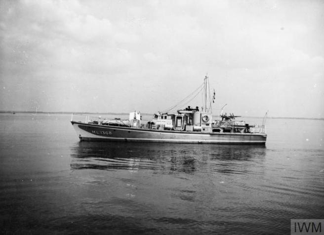 Historic black & white photograph of motor launch seen in longitudinal profile in calm seas, her number ML 1368 visible on her bows to the left. 