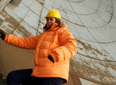 Woman In Orange Coat In Tower