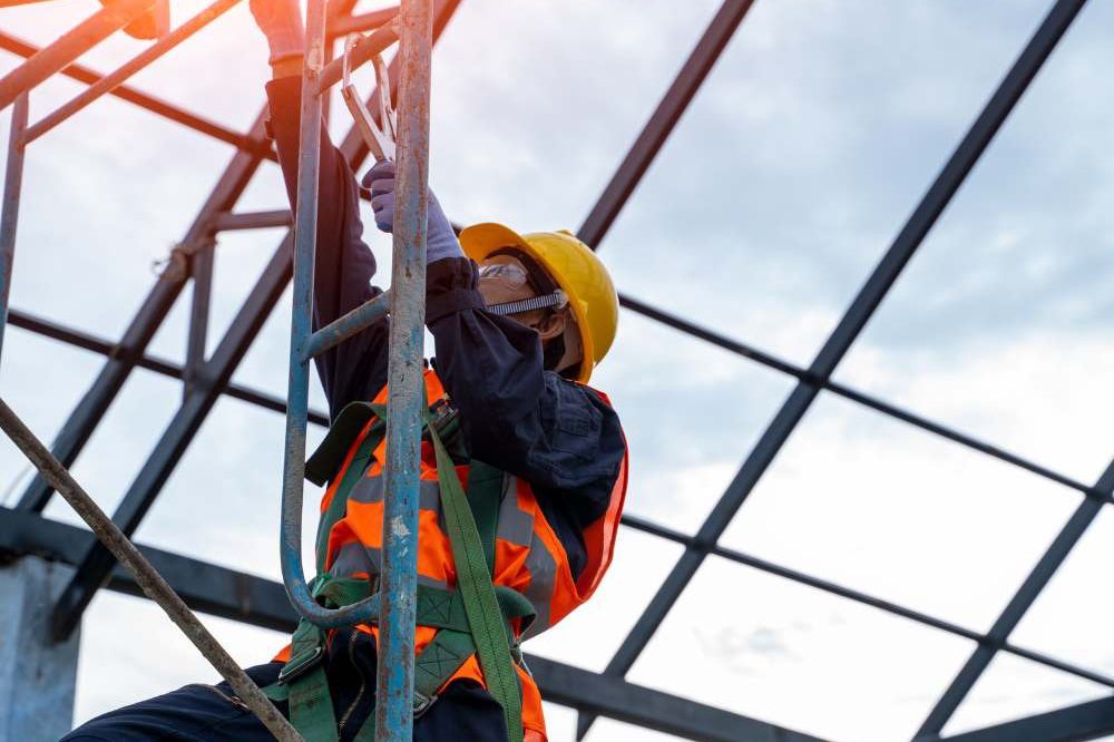 Person In A Harness Erecting Steel