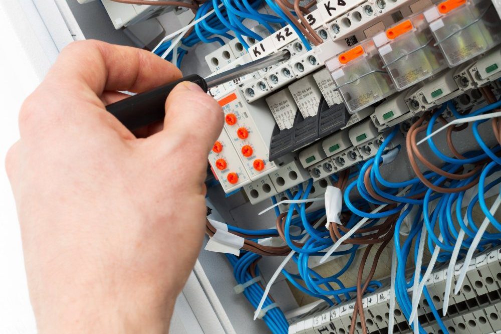 Person Tightening Screw On Consumer Unit