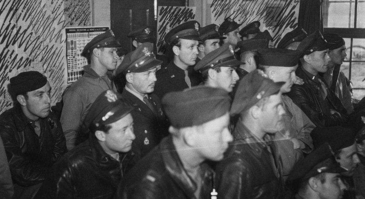 In Duxford’s Briefing Room, American P-47 pilots gather before escorting B-17s over occupied Europe.