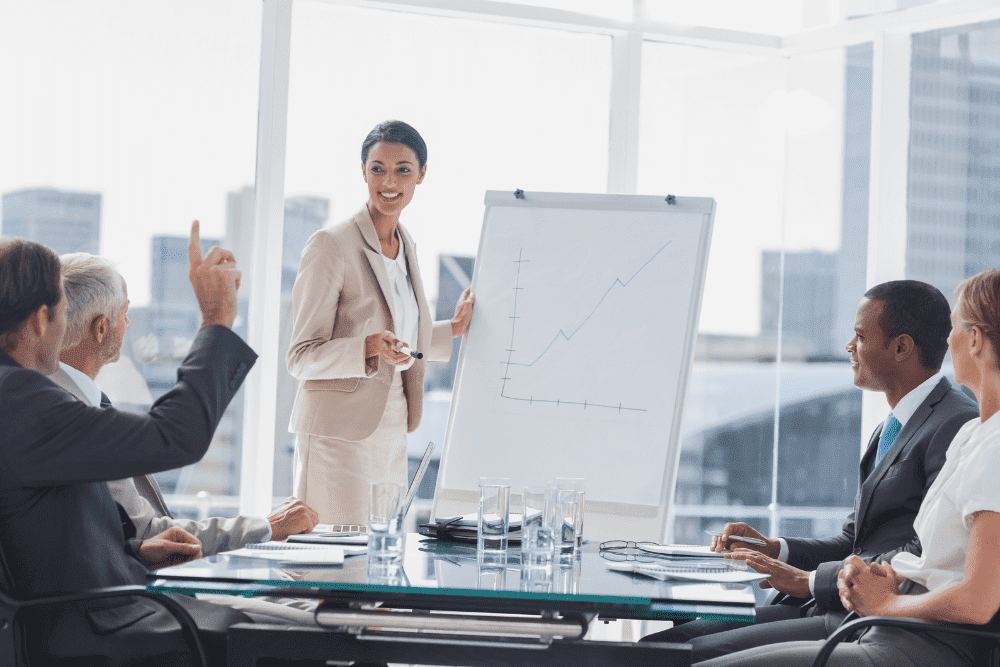 Woman Presenting Graph In Office Meeting