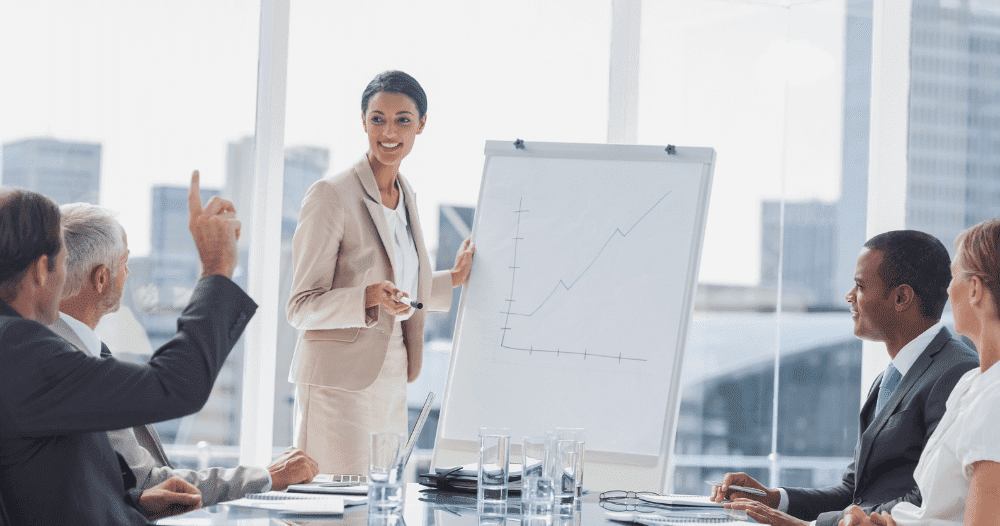 Woman Presenting Graph In Office Meeting