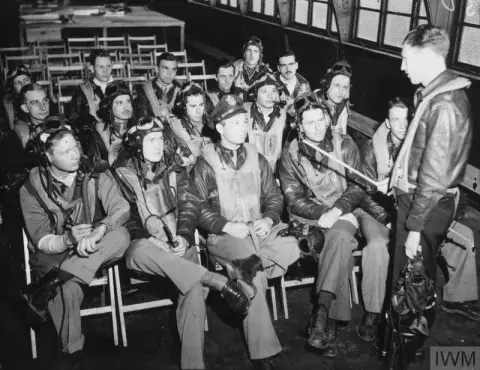 Pilot of the 353rd Fighter Group in the briefing room.
