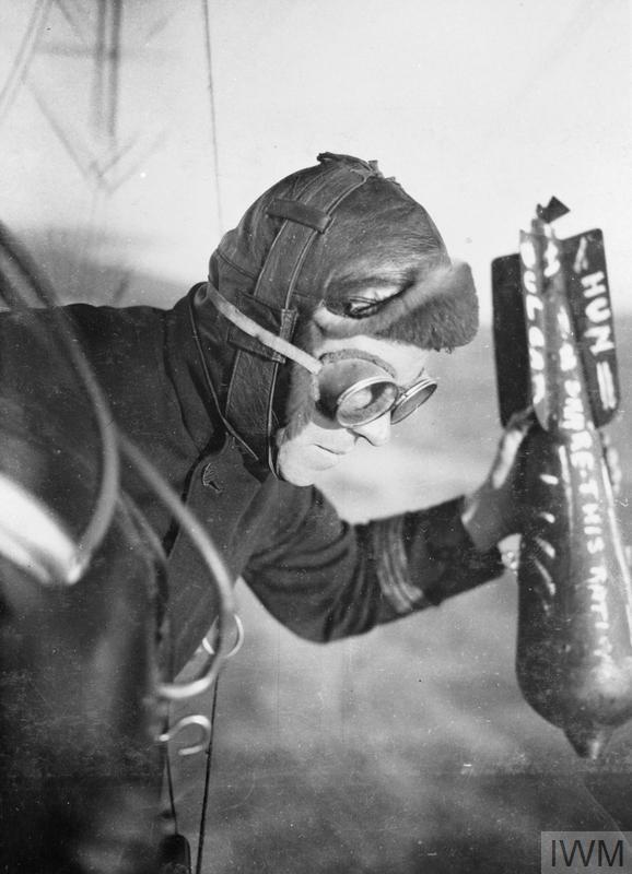 A British airman dropping a bomb during the First World War