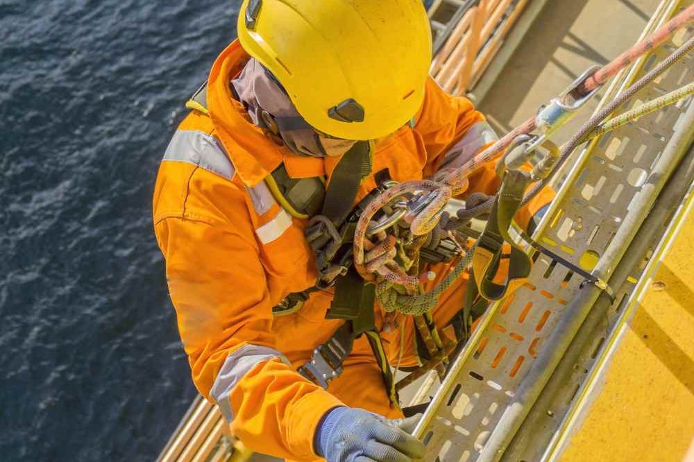 Person Climbing Offshore With Ropes