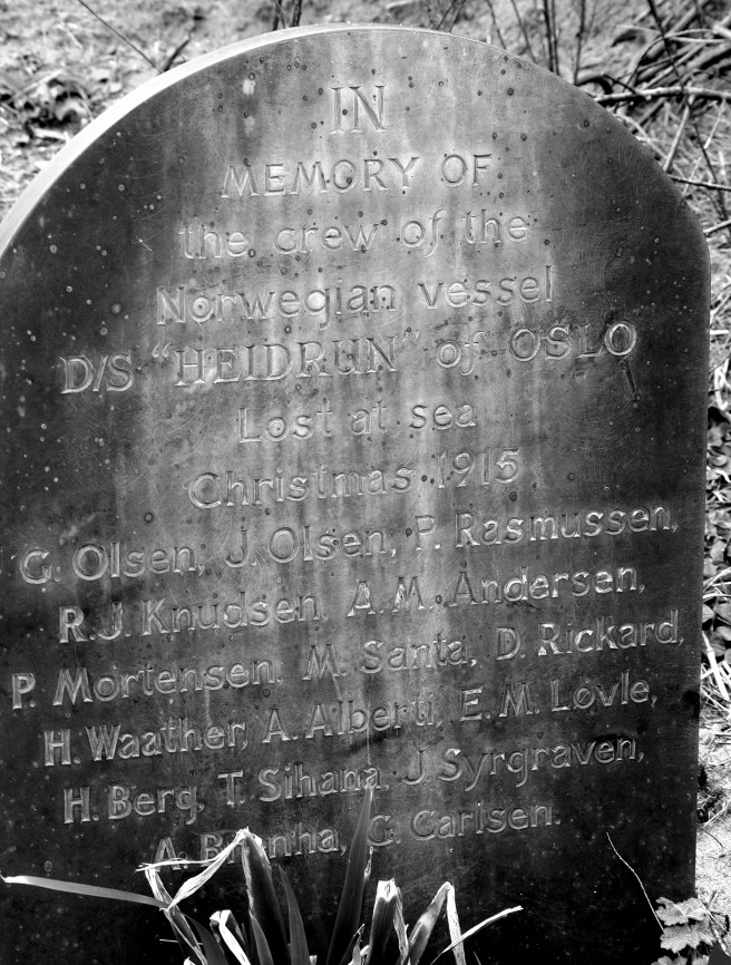 Modern B&W photograph of simple gravestone carved only with text.