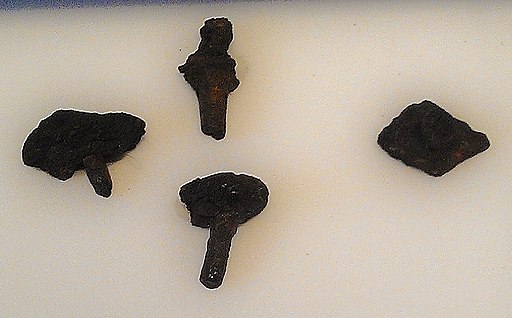 Four incomplete iron rivets seen against a white background.
