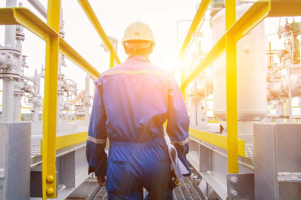 Man In Blue Overalls On Site
