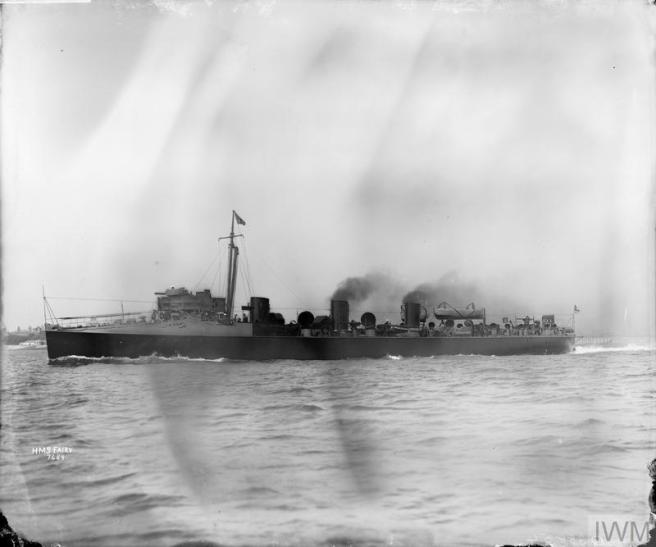 B&W photograph of ship in port broadside view, smoke billowing.