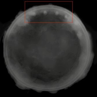 x ray of whole pan, with 4 rivets showing up as small white round features at top