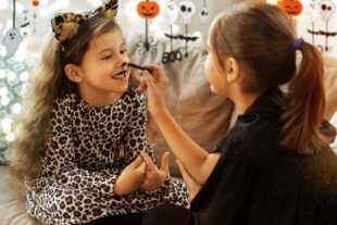 Young girl in pussy cat costume gets ready for Halloween. Avoiding counterfeit costumes. This image illustrates our article about counterfeit costumes. If the price seems too good to be true, it probably is.