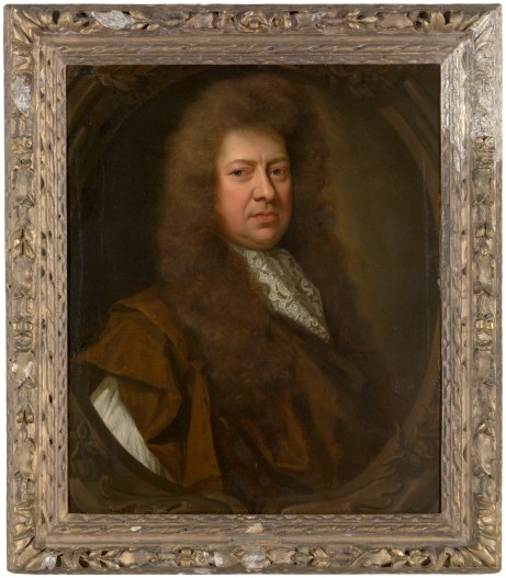 Portrait of Samuel Pepys in old age, wearing a wig and facing right against a dark background, in a gold frame.