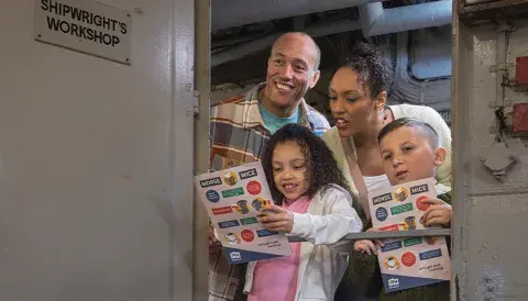 Family inside HMS Belfast on a trail