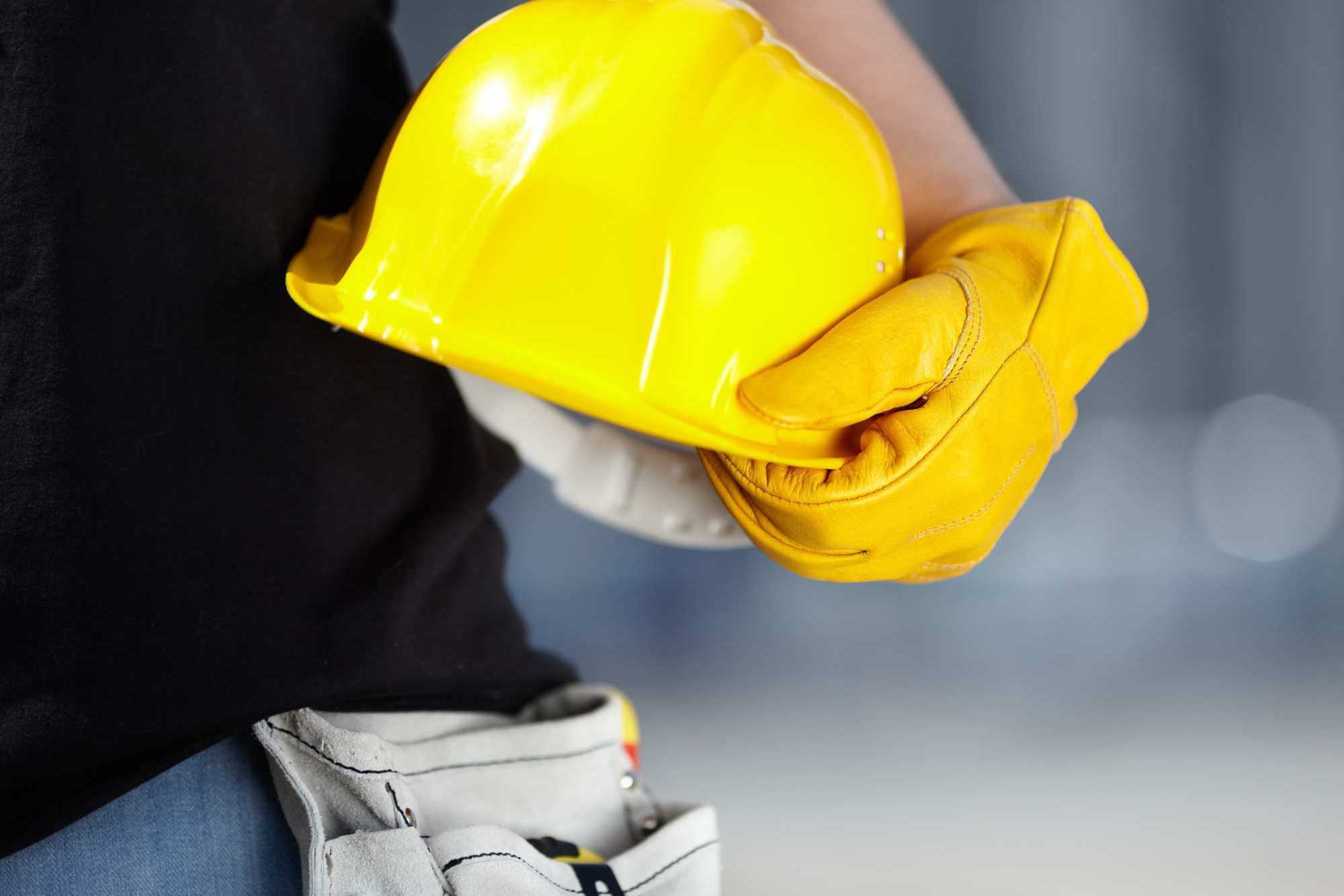 Person Holding Yellow Hard Hat