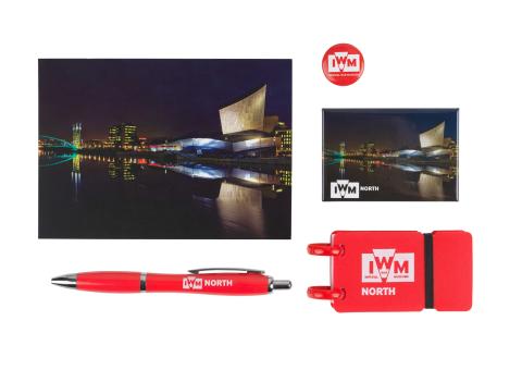 IWM North souvenir gift bag featuring IWM North Air exterior postcard  IWM North photographic magnet  Red IWM mini button badge  Red IWM North mini notepad  Red IWM North grip pen