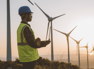 Graduate At Sunset Inspecting Wind Turbines
