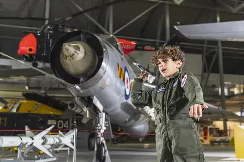 Boy throwing a paper aircraft inside AirSpace