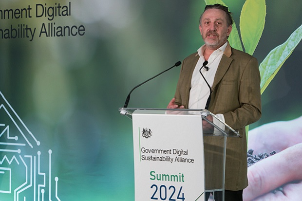 A man standing at a lectern.