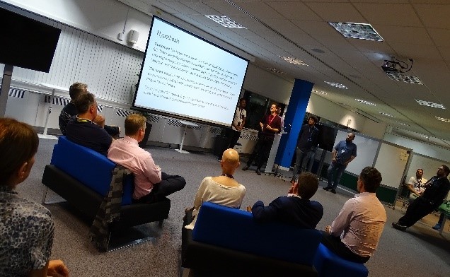 Hackathon Shipley pitches taking place in front of a large screen
