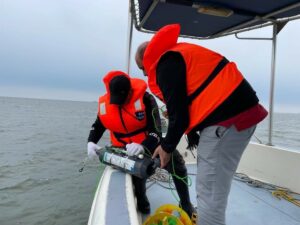 people on a boat with science equipment