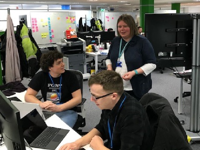 Debs Sunter talking to two apprentices