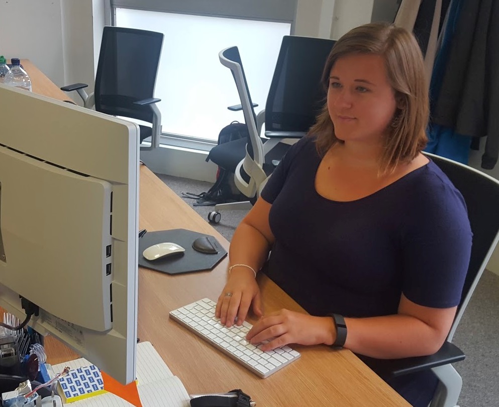 Beccy Stafford HMRC Platform Test Lead sitting at a desk with monitor