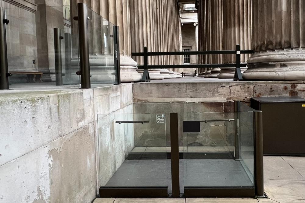 Glass-sided lift, providing access from the forecourt level to the entrance level. 