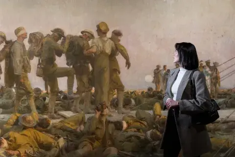 Visitor standing in front of a painting at IWM London