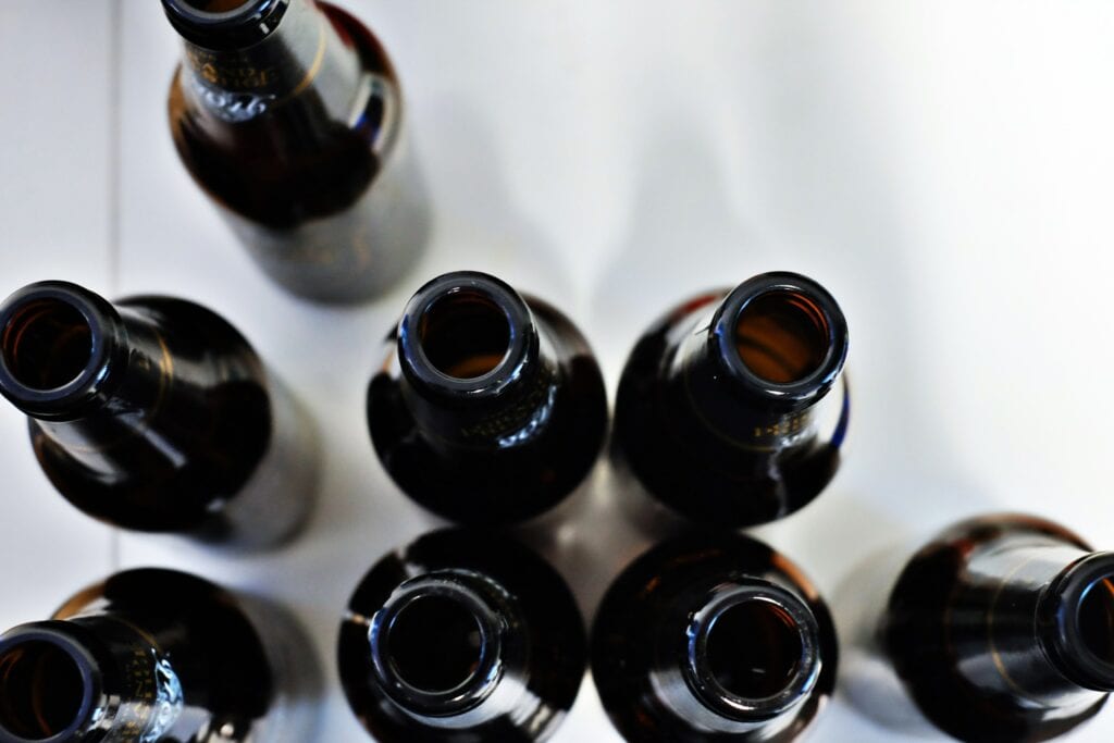 several empty black bottles photographed from above