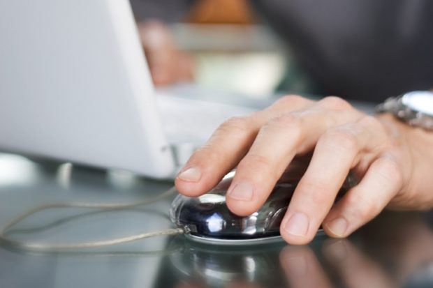 Hand on a laptop mouse