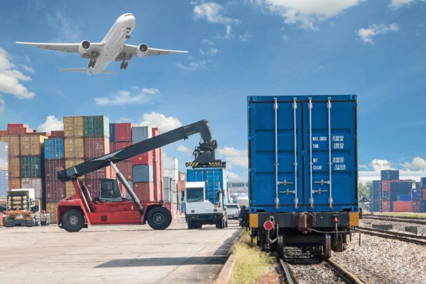 Forklift handling container box loading to freight train