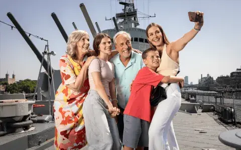 Family take a selfie together on the deck of HMS Belfast