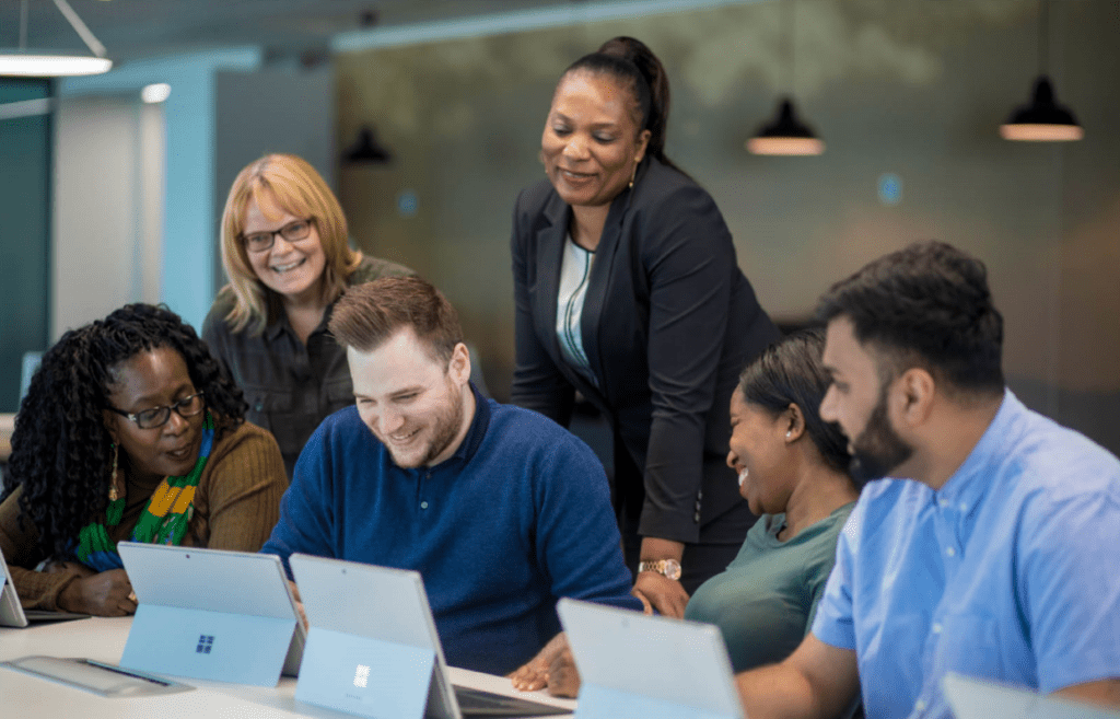 Colleagues working around laptops